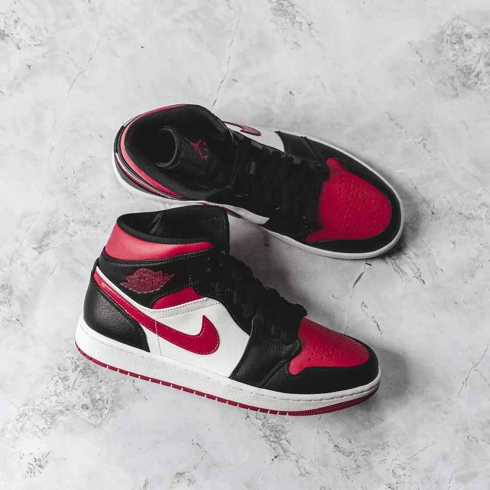 Air Jordan 1 Mid Bred Toe sneakers.