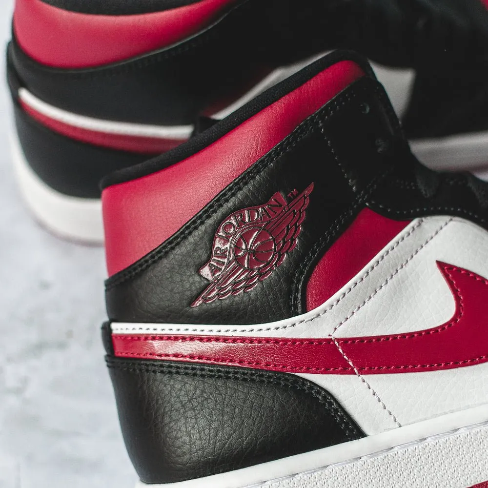 Air Jordan 1 Mid Bred Toe sneakers.