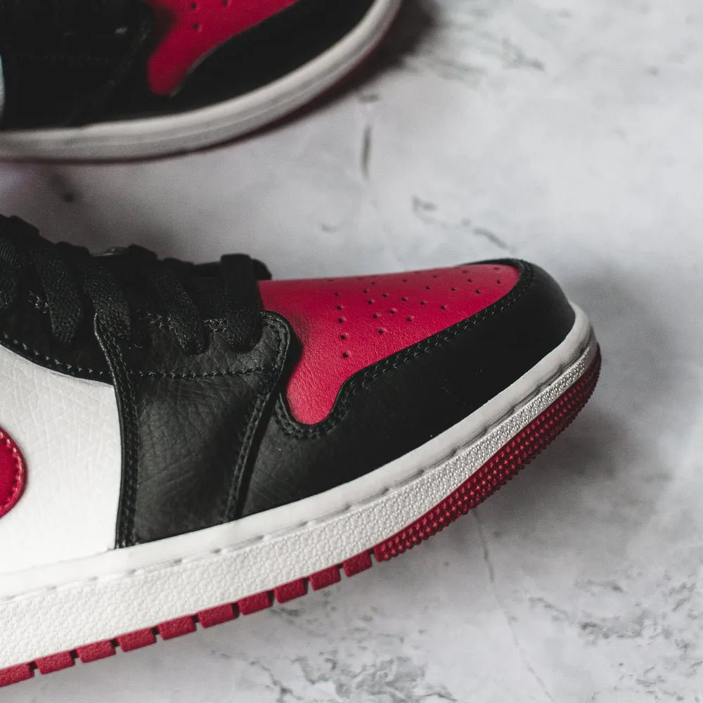 Air Jordan 1 Mid Bred Toe sneakers.